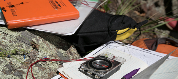 photo of field books and compass