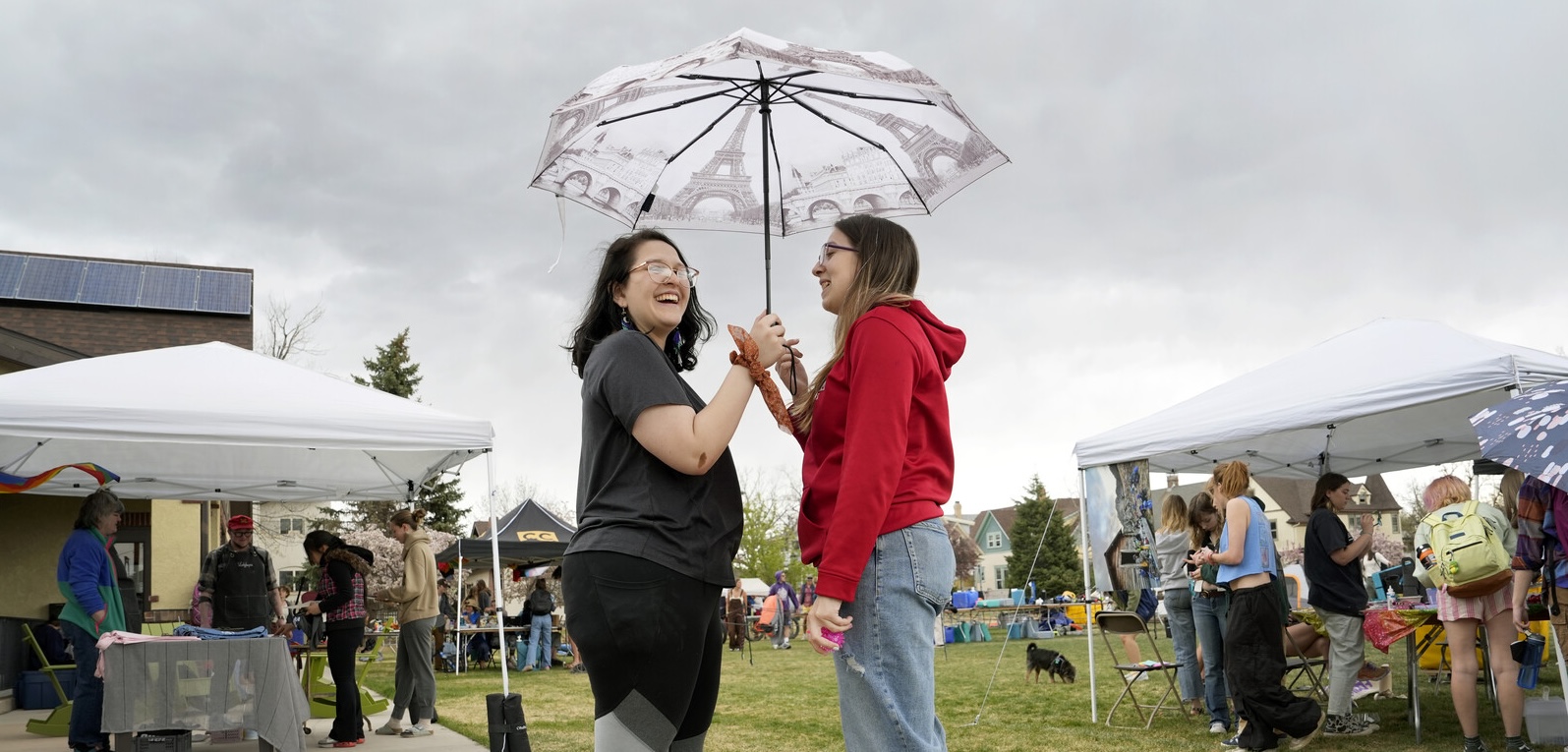 One student shared her small umbrella with another student