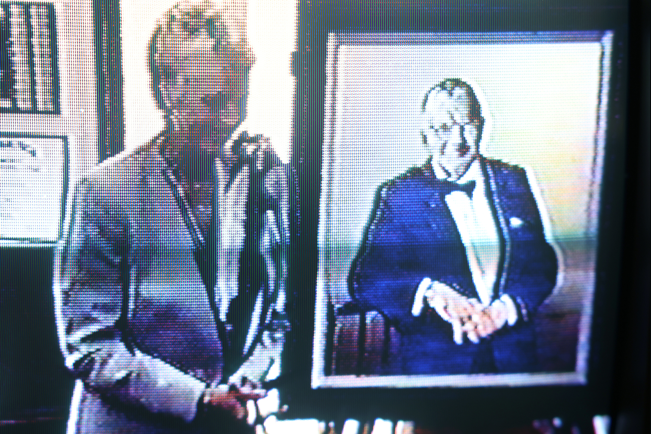 A still shot taken from the same video in 1994 showing Pat Lyon standing next to her husband George Lyon's portrait. Courtesy CC Special Collections