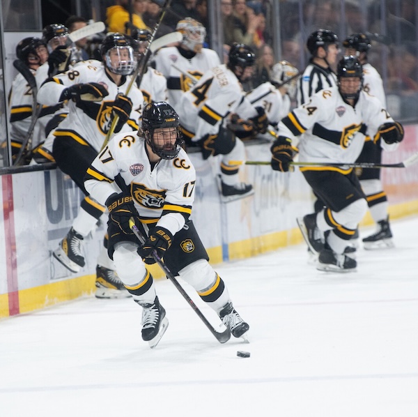 a hockey player puckhandles in Robson arean