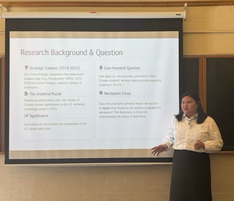 Perilla Wang '28 presents at the front of the room