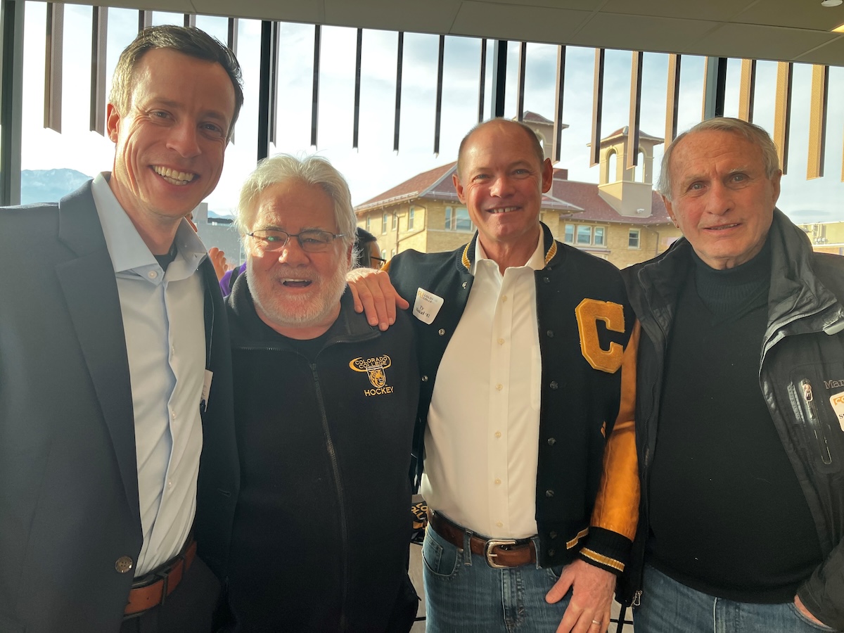 4 men wearing Colorado College hockey jerseys