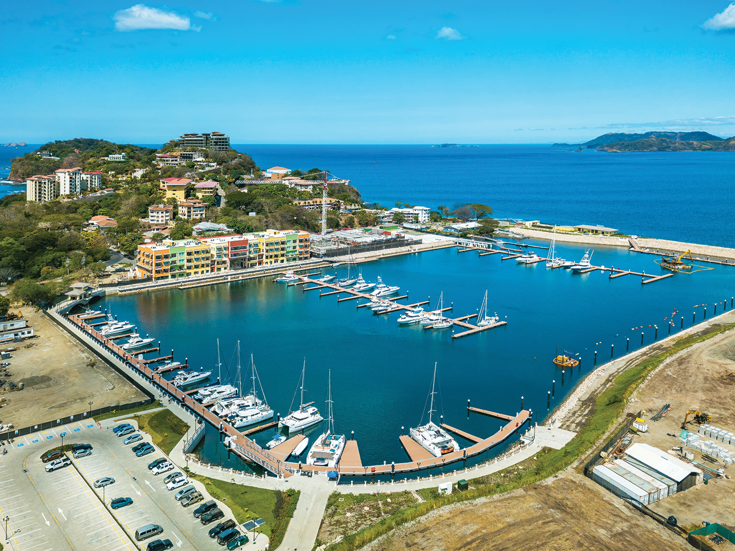 The Marina Flamingo in Costa Rica is a marina full of boats of different sizes tucked against a town.